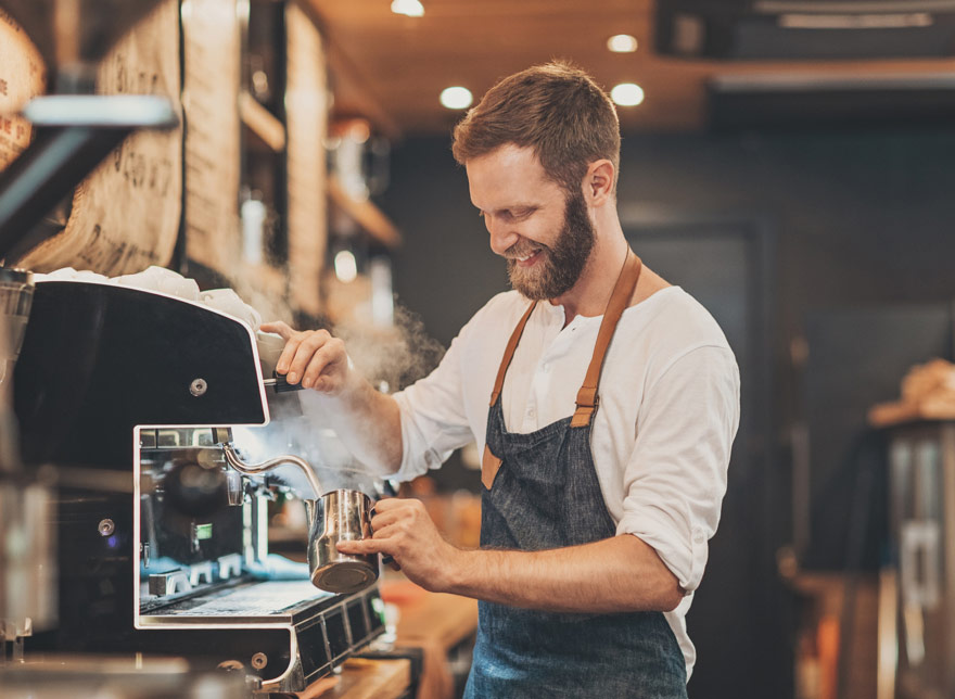 a barista working in a busy coffee shop.